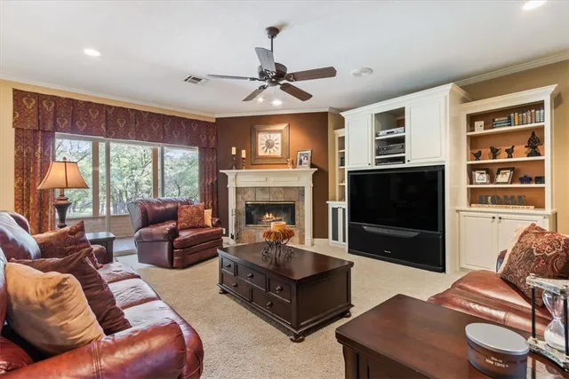 a living room with furniture a large window and a fireplace