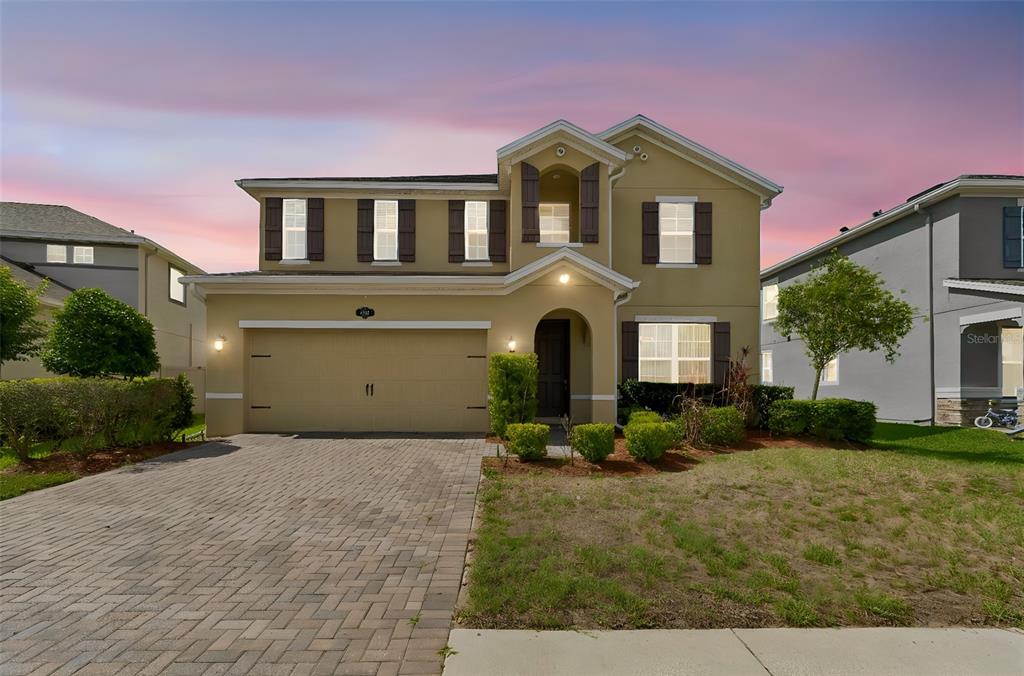1192 Multiflora Loop Lutz, FL 33558 - Photo 1 of 32 a front view of a house with garden
