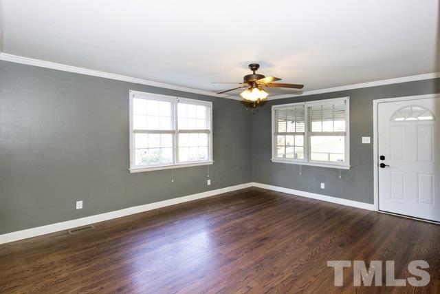 1212 North King Charles Road Raleigh, NC 27610 - Photo 4 of 16 a view of an empty room with wooden floor and a window