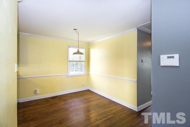1212 North King Charles Road Raleigh, NC 27610 - Photo 5 of 16 an empty room with wooden floor and windows