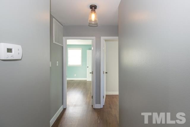 1212 North King Charles Road Raleigh, NC 27610 - Photo 10 of 16 a view of a hallway with wooden floor