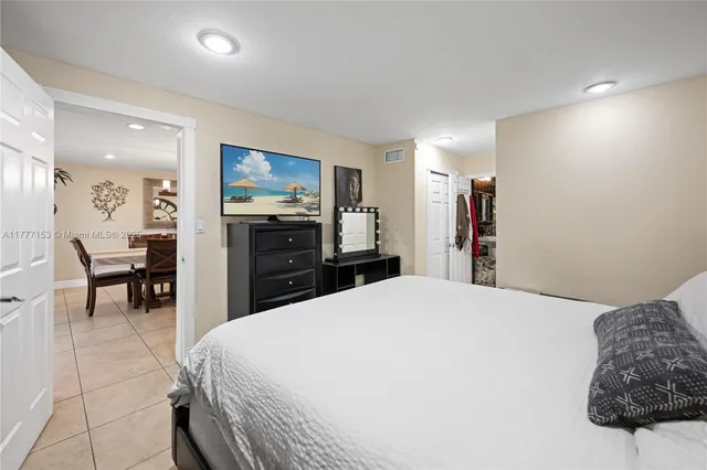 a large bedroom with a bed and furniture