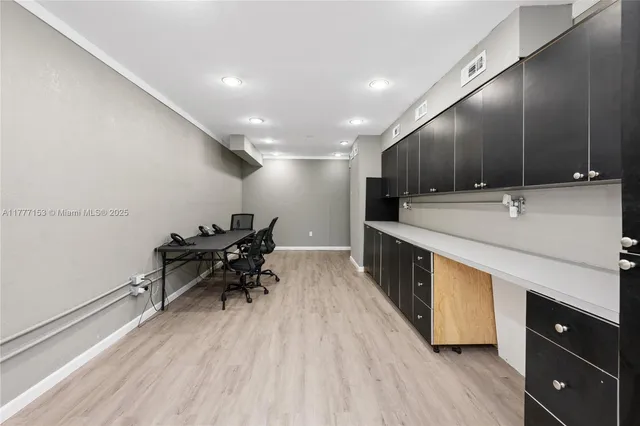 a kitchen with stainless steel appliances granite countertop a sink dishwasher a stove and a refrigerator with wooden floor