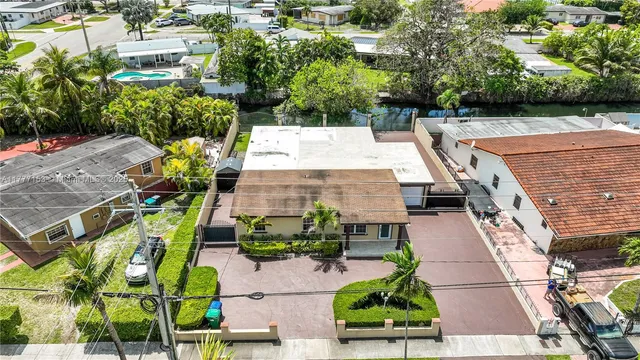 an aerial view of a house with large trees