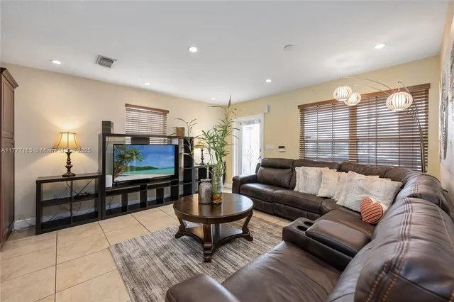 a living room with furniture a rug and a flat screen tv