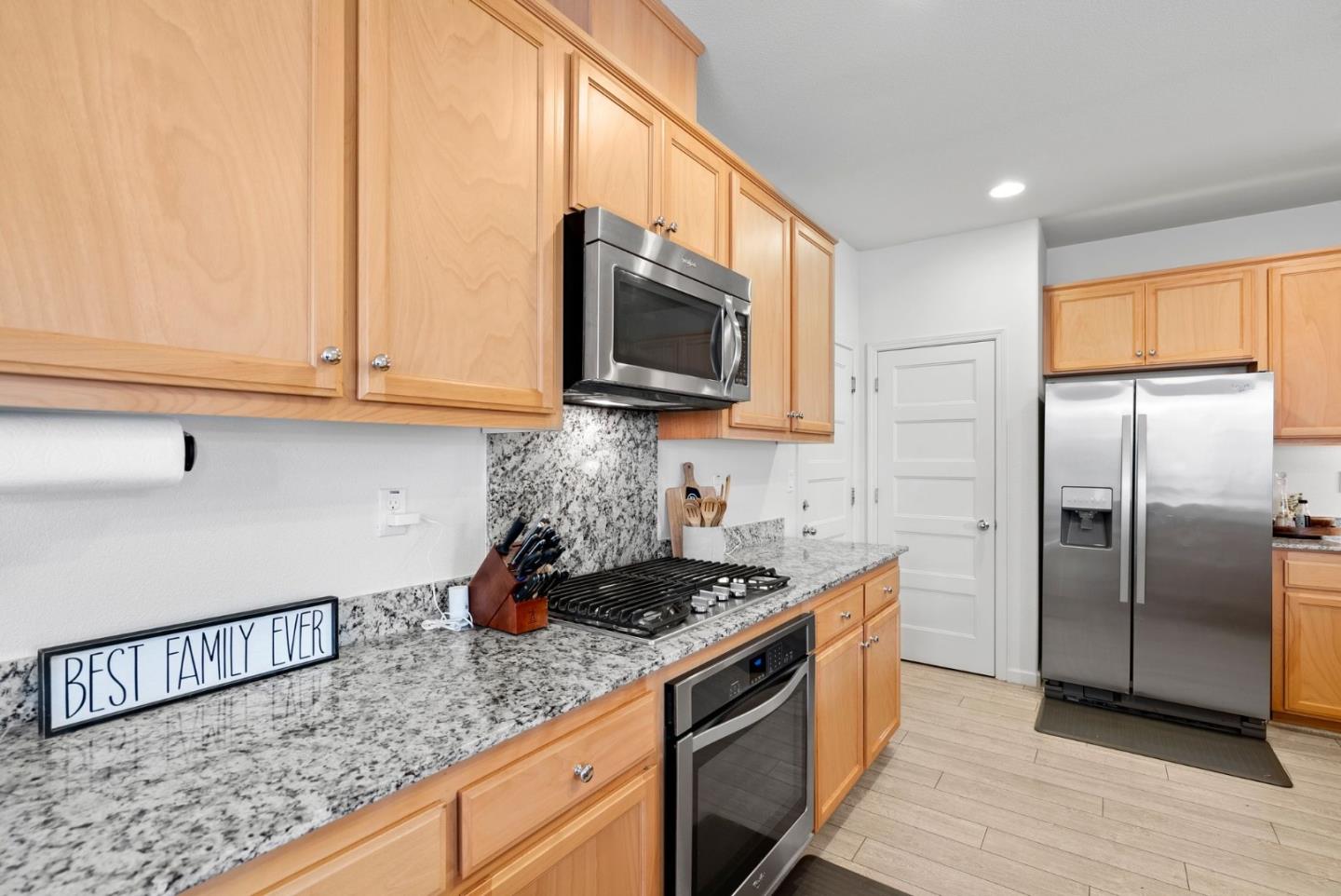 94 Caspian Way Gilroy, CA 95020 - Photo 13 of 40 a kitchen with stainless steel appliances granite countertop a sink a stove and a microwave
