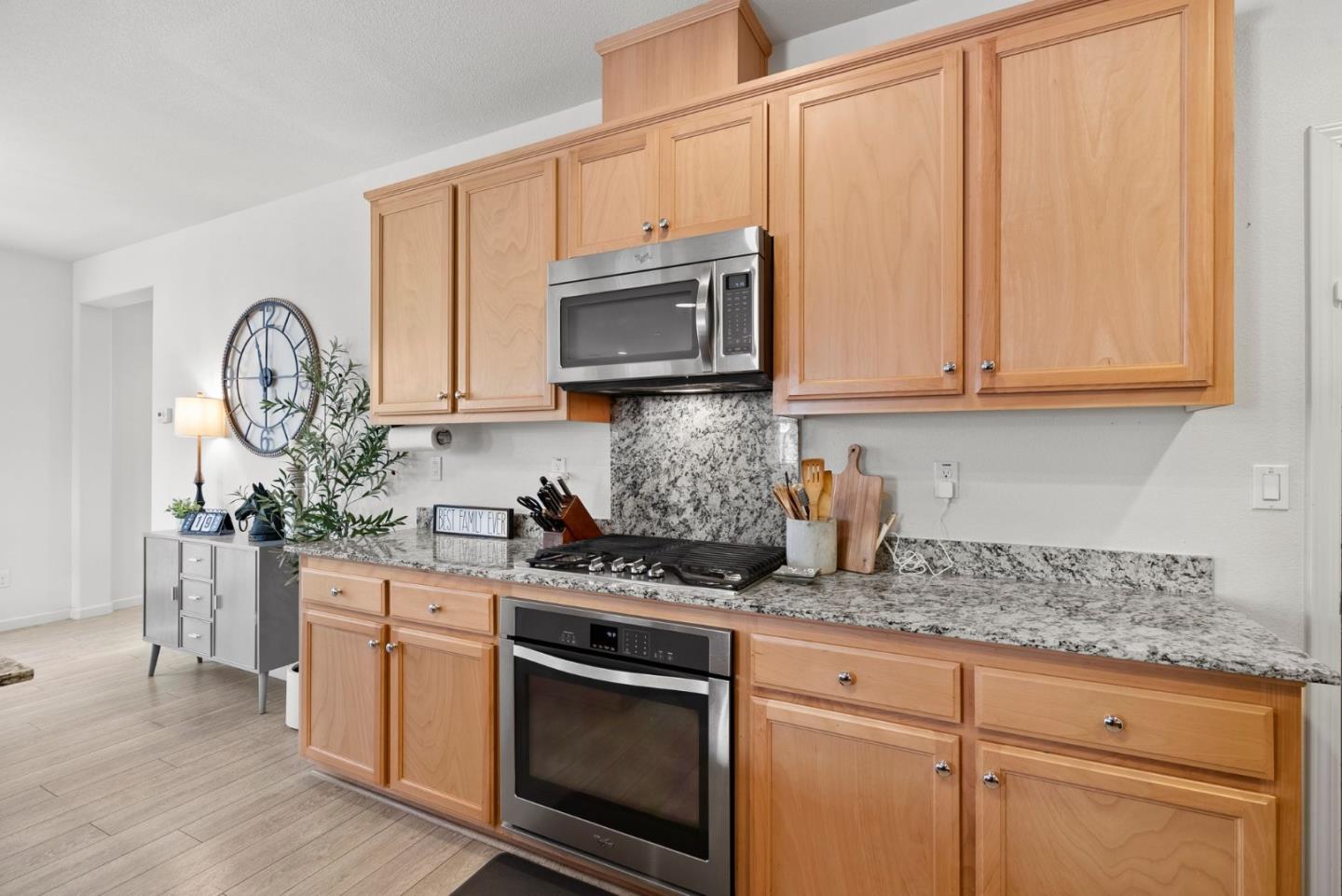 94 Caspian Way Gilroy, CA 95020 - Photo 15 of 40 a kitchen with stainless steel appliances granite countertop a stove a sink and a microwave