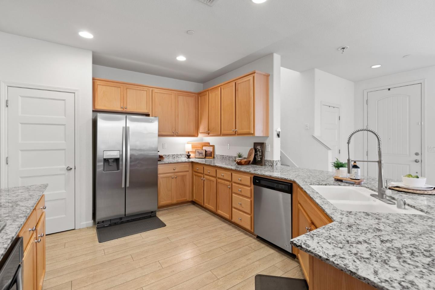 94 Caspian Way Gilroy, CA 95020 - Photo 18 of 40 a kitchen with stainless steel appliances granite countertop a sink stove and refrigerator