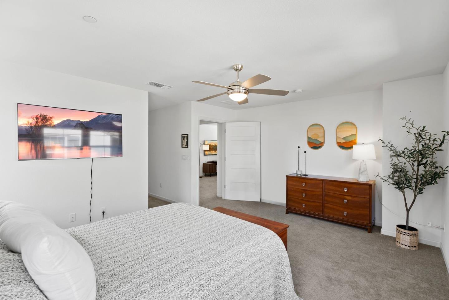 94 Caspian Way Gilroy, CA 95020 - Photo 28 of 40 a bedroom with a bed and a chandelier