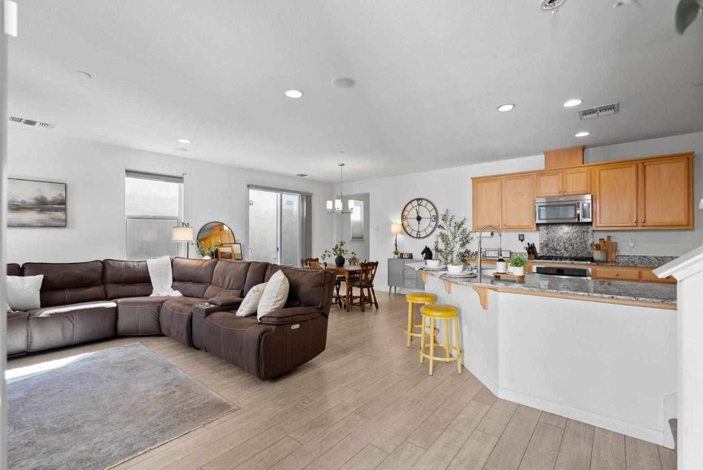 94 Caspian Way Gilroy, CA 95020 - Photo 5 of 40 a living room with furniture kitchen view and a wooden floor