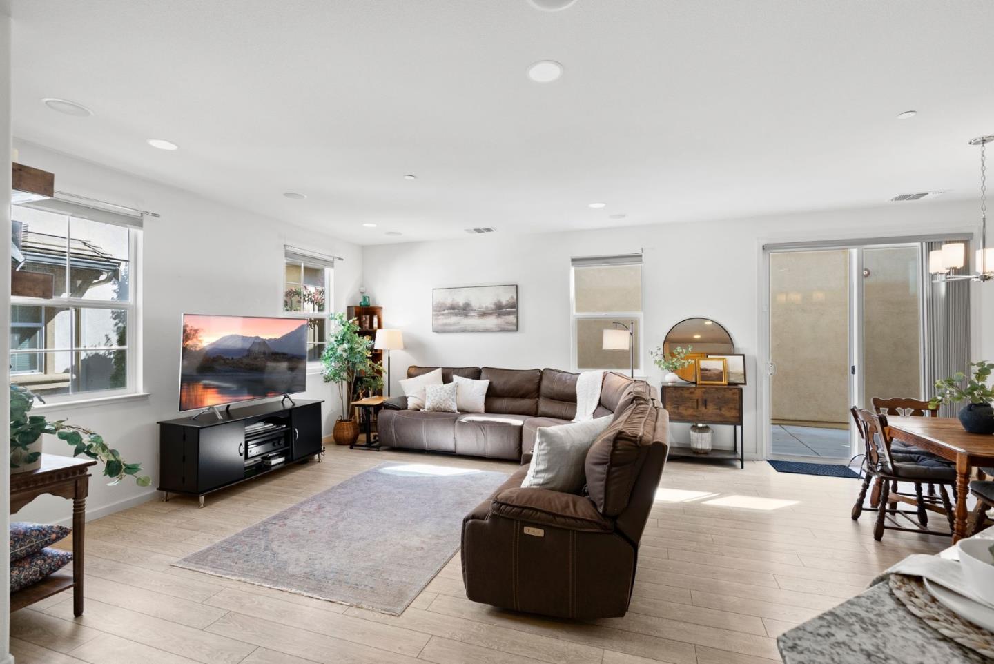 94 Caspian Way Gilroy, CA 95020 - Photo 6 of 40 a living room with furniture a flat screen tv and a fireplace