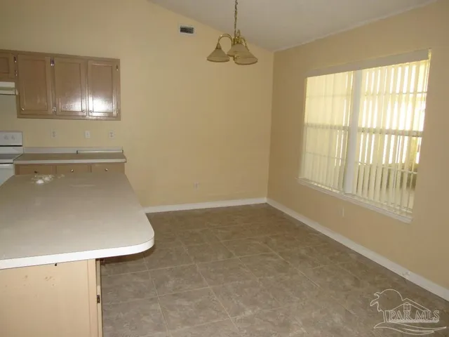 a room with a window and chandelier