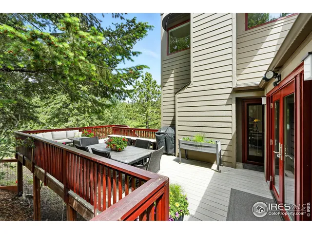 a balcony view with two chairs and a potted plant