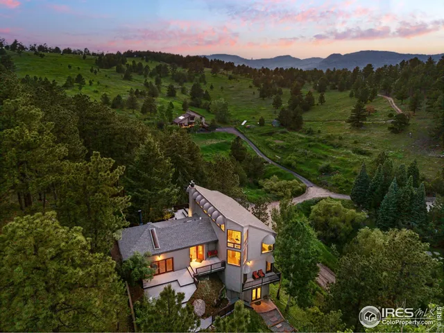 an aerial view of a house with mountain view