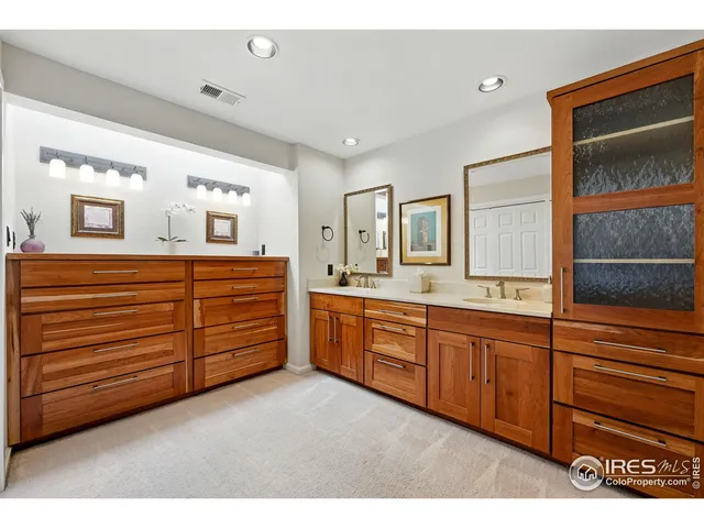 a spacious bathroom with a granite countertop sink and a mirror