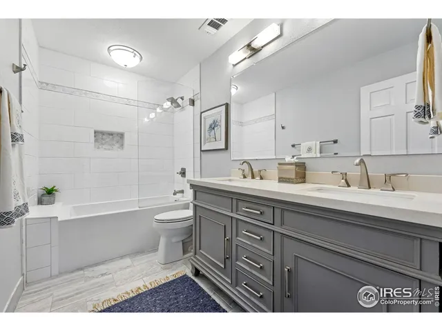 a bathroom with a tub sink toilet and a mirror