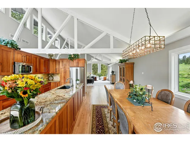 a view of a dining room with furniture wooden floor and chandelier