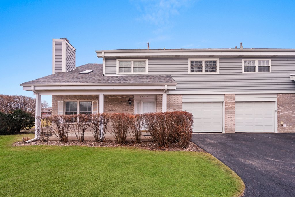 a front view of house with yard and outdoor seating