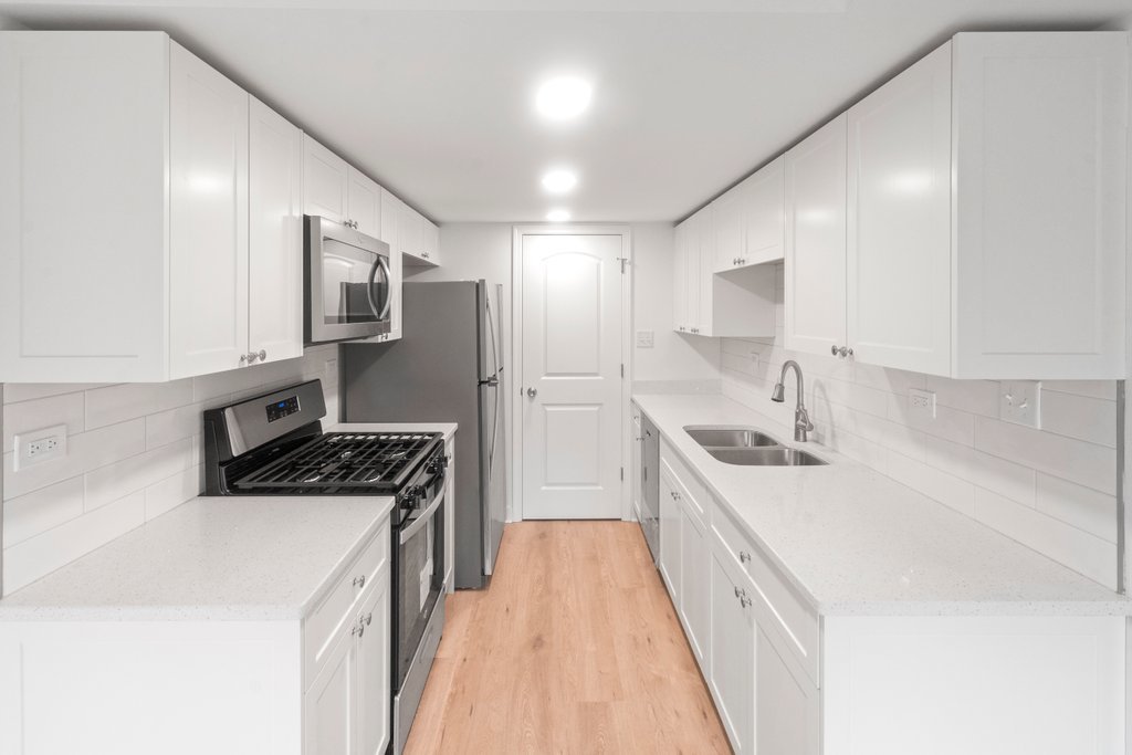 7050 Olde Gatehouse Road Tinley Park, IL 60477 - Photo 14 of 37 a kitchen with stainless steel appliances a sink stove and cabinets