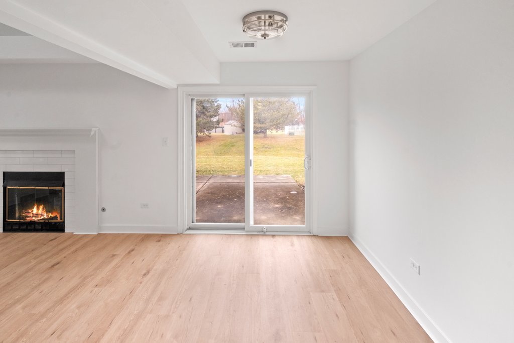 7050 Olde Gatehouse Road Tinley Park, IL 60477 - Photo 15 of 37 a view of an empty room with wooden floor and a window