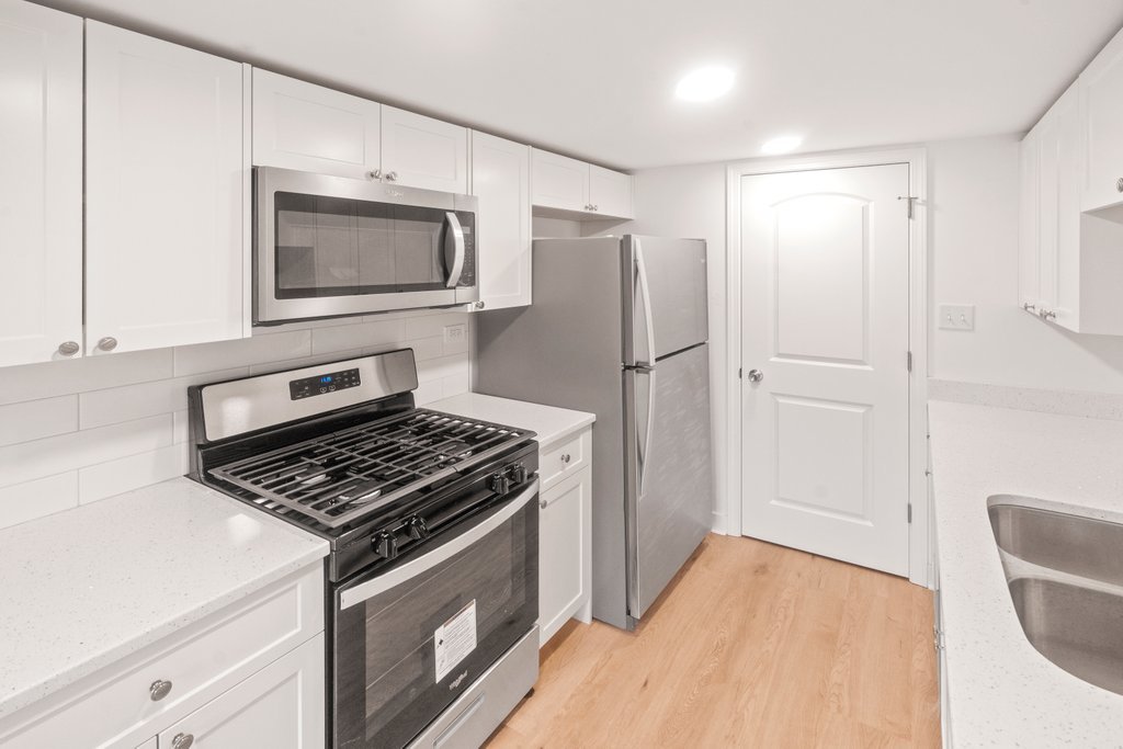 7050 Olde Gatehouse Road Tinley Park, IL 60477 - Photo 16 of 37 a kitchen with a stove and a microwave