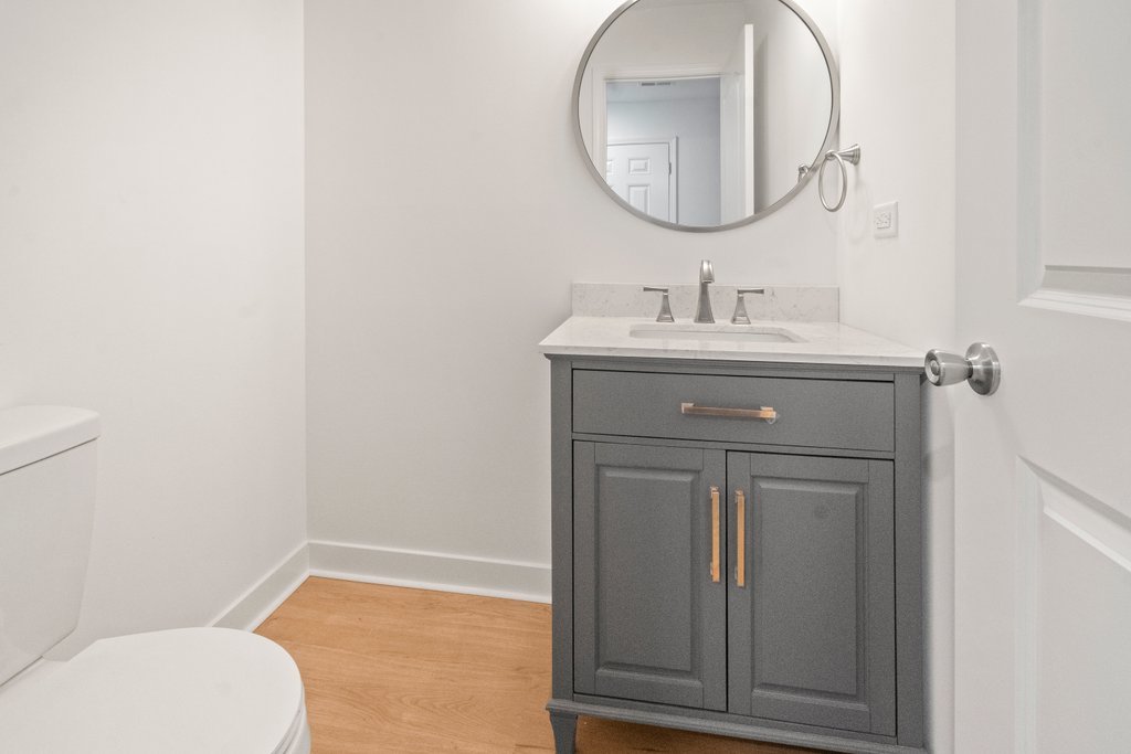 7050 Olde Gatehouse Road Tinley Park, IL 60477 - Photo 19 of 37 a bathroom with a toilet a sink and mirror
