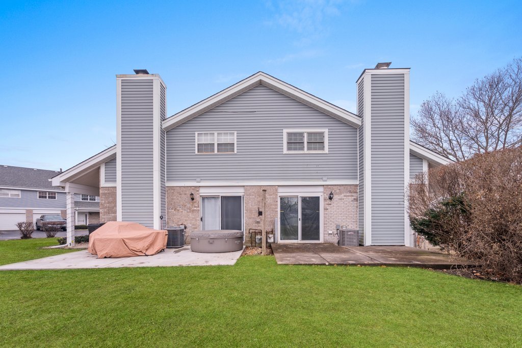 7050 Olde Gatehouse Road Tinley Park, IL 60477 - Photo 2 of 37 a front view of house with a garden and patio