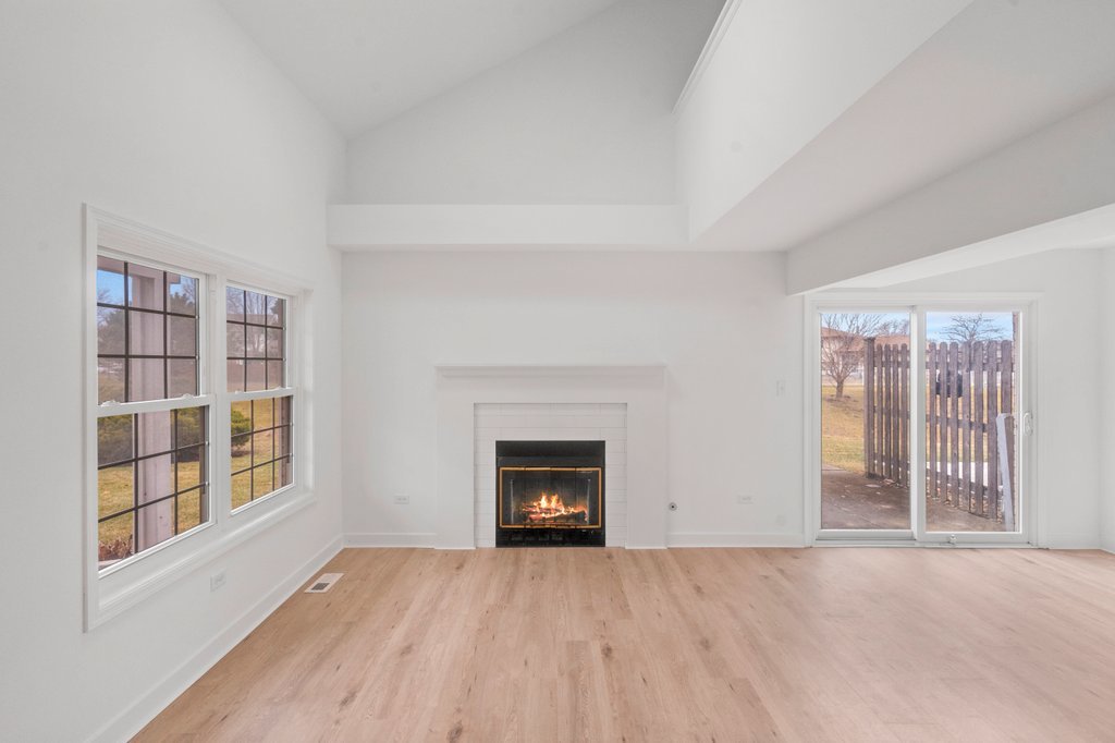 7050 Olde Gatehouse Road Tinley Park, IL 60477 - Photo 8 of 37 a view of an empty room with a window and fireplace