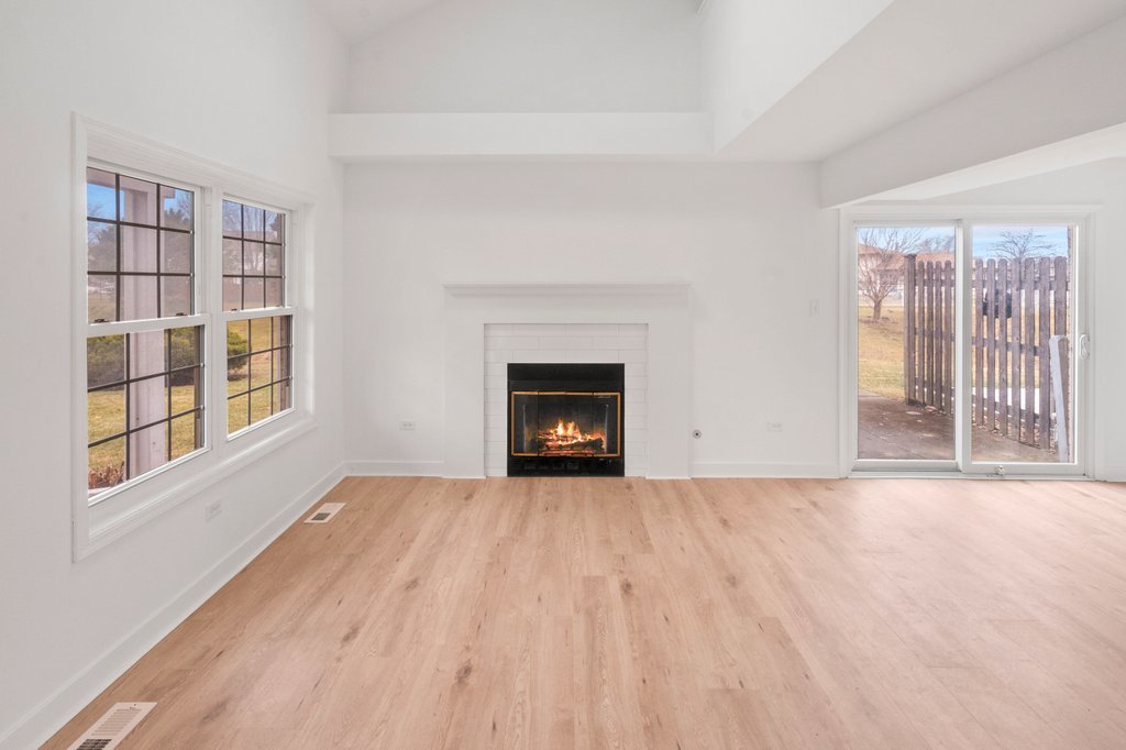 7050 Olde Gatehouse Road Tinley Park, IL 60477 - Photo 9 of 37 wooden floor fireplace and windows in a room