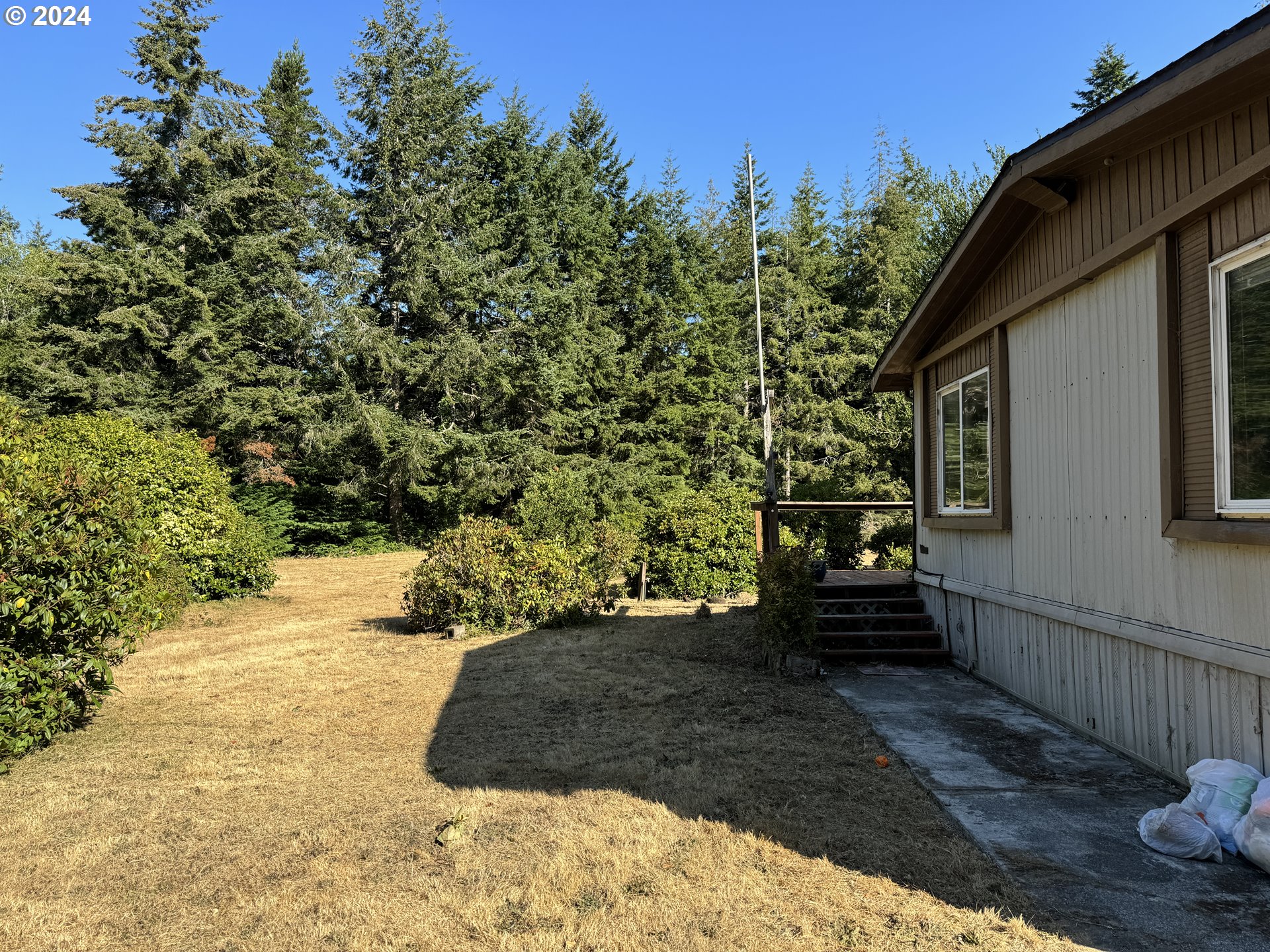 55985 Fishtale Road Bandon, OR 97411 - Photo 2 of 8 a view of garden with patio