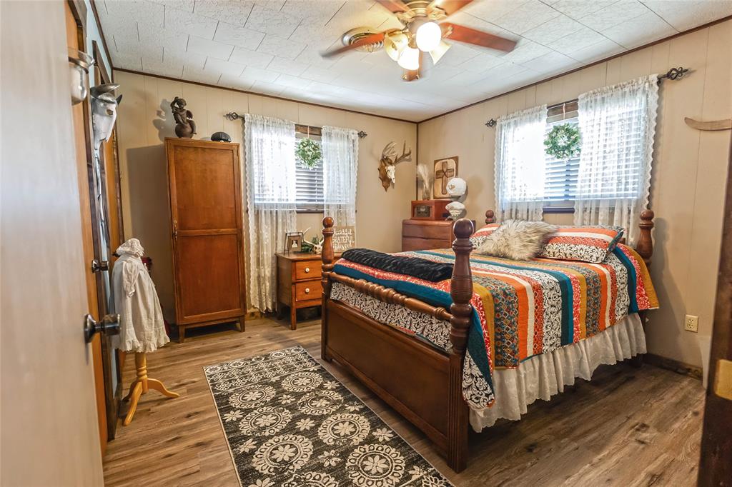 978 Longbranch Road Nocona, TX 76255 - Photo 21 of 40 a bed room with a bed and a chandelier