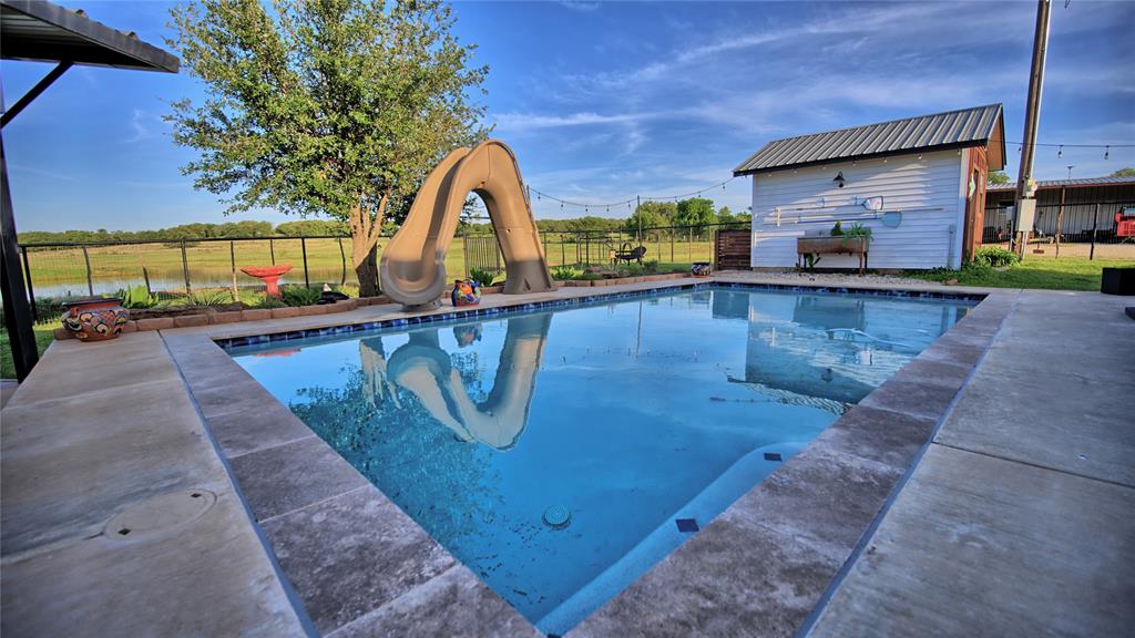 978 Longbranch Road Nocona, TX 76255 - Photo 6 of 40 a view of a swimming pool with a patio