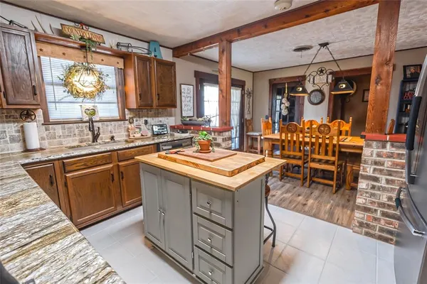 a kitchen with stainless steel appliances granite countertop a stove a sink and a refrigerator