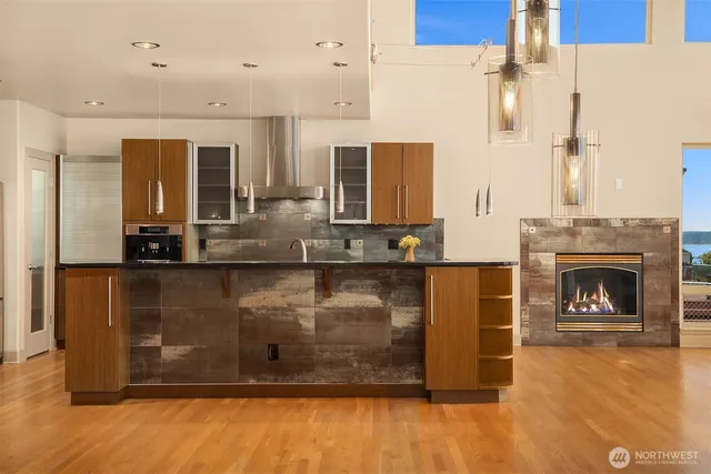 a bathroom with a granite countertop sink a mirror and shower