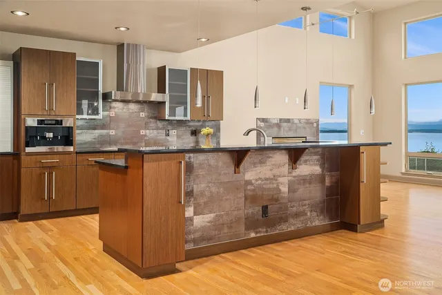 a large kitchen with kitchen island granite countertop a sink and cabinets