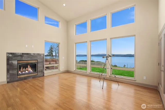 a view of an empty room with a fireplace and a window