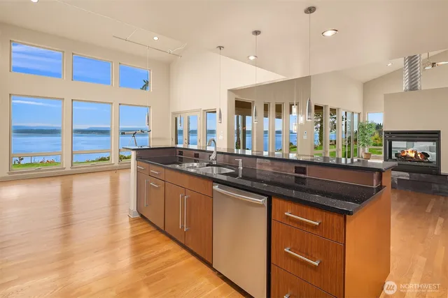 a kitchen with stainless steel appliances granite countertop a sink and wooden cabinets