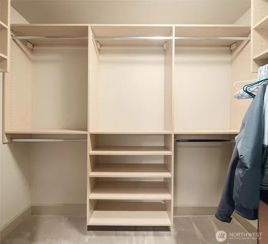 a view of walk in closet with empty racks