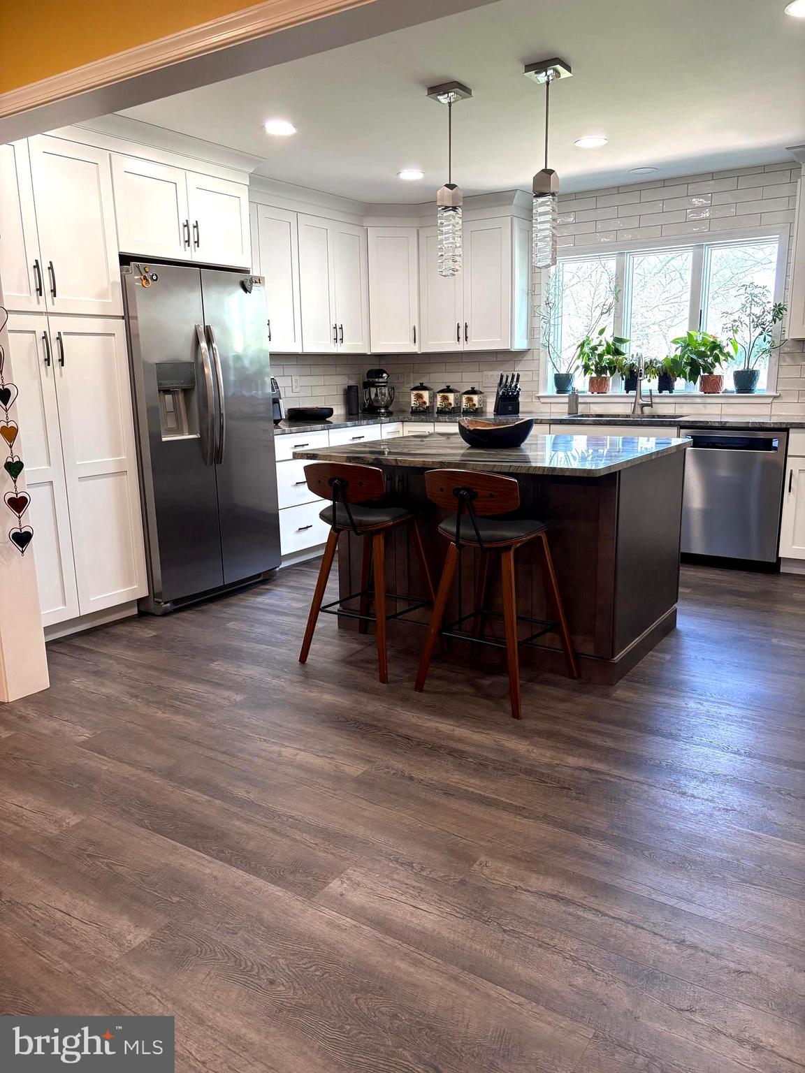 412 Greentree Road Sewell, NJ 08080 - Photo 4 of 5 a kitchen with stainless steel appliances kitchen island granite countertop a refrigerator a sink a stove a dining table and chairs