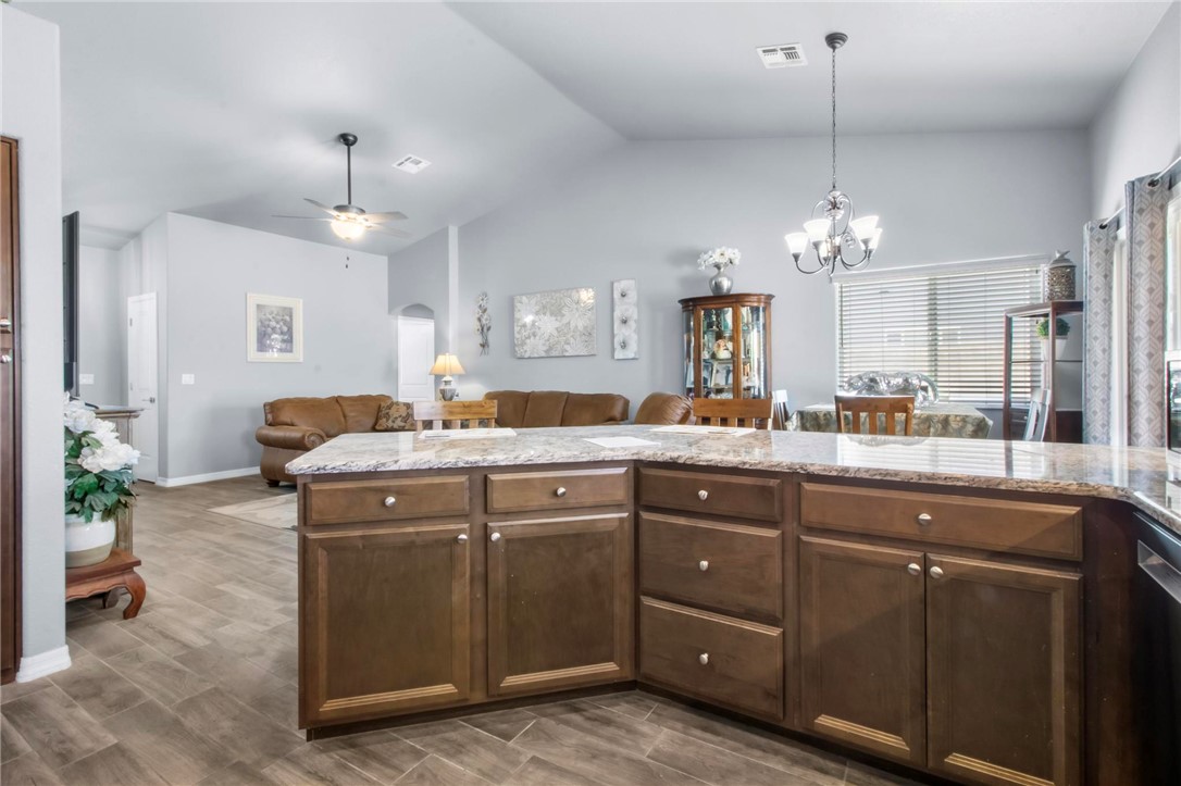 3897 Easy Street Kingman, AZ 86409 - Photo 14 of 53 a spacious bathroom with a granite countertop sink a mirror and a chandelier