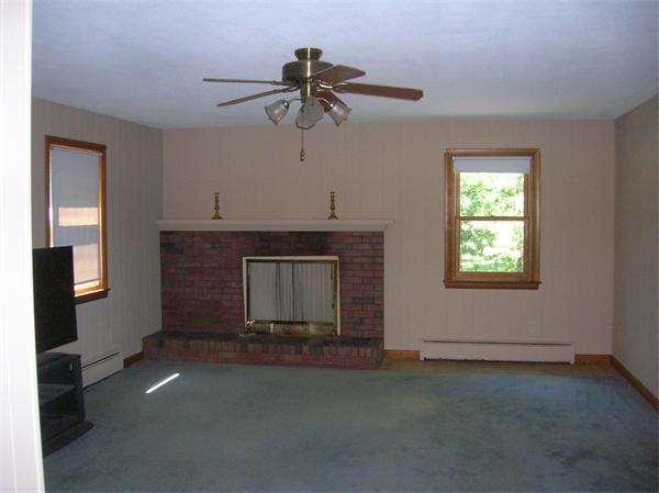 454 Dipping Hole Road Wilbraham, MA 01095 - Photo 3 of 14 a living room with a fireplace and a window