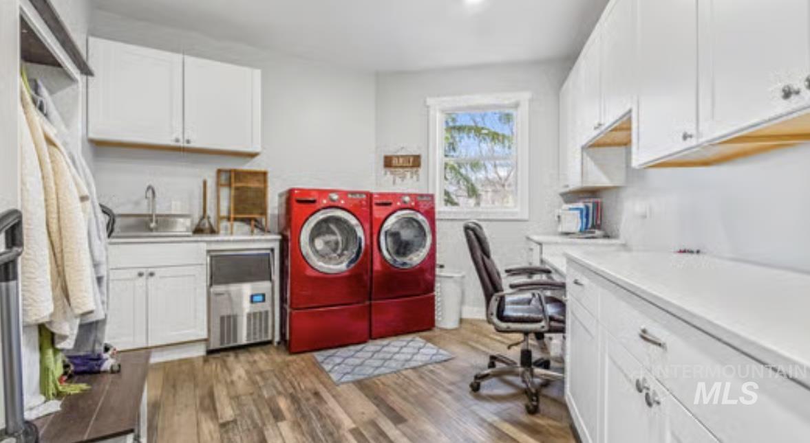 16353 Brunello Court Caldwell, ID 83607 - Photo 26 of 34 Washroom featuring wood finished floors, washer and dryer, cabinet space, and an office area