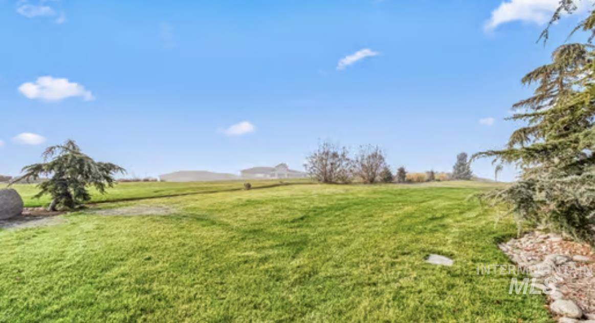 16353 Brunello Court Caldwell, ID 83607 - Photo 33 of 34 View of green lawn featuring a view of rural / pastoral area