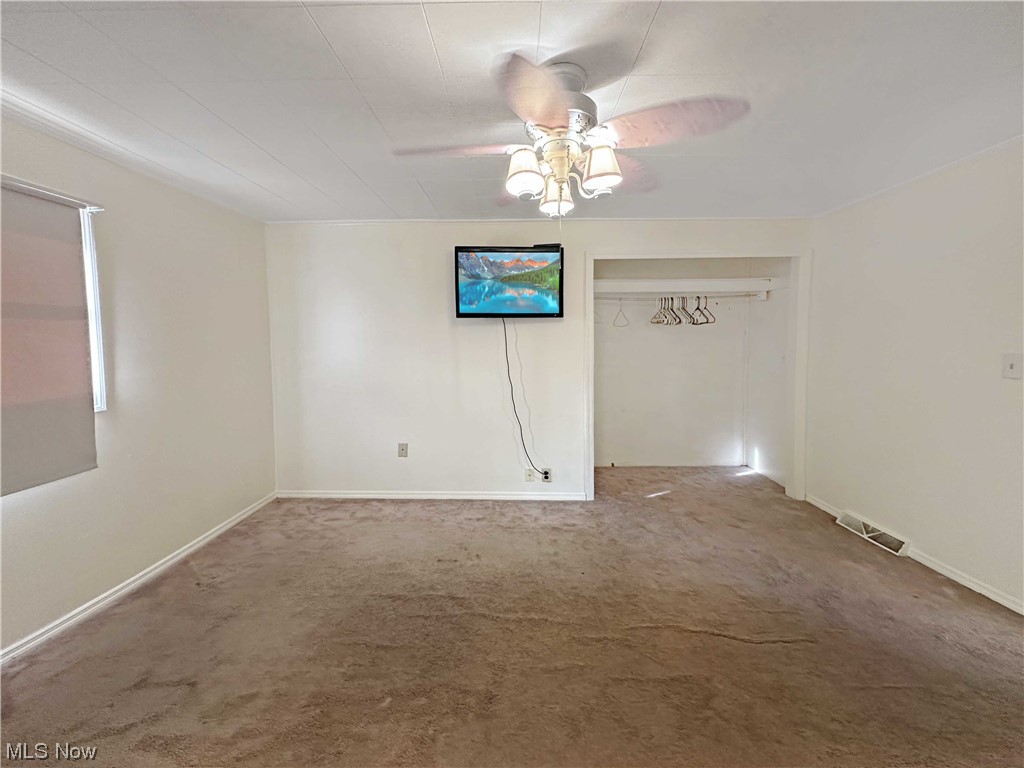 2692 Race Track Road New Cumberland, WV 26047 - Photo 15 of 25 Carpeted empty room featuring ceiling fan