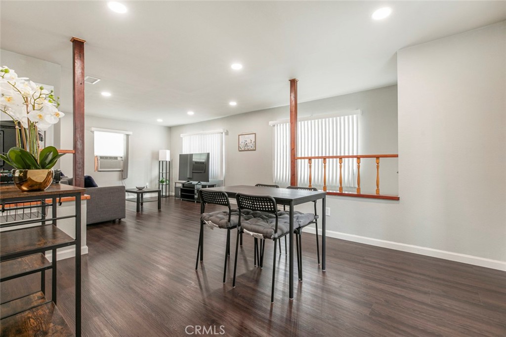13166 Aztec Street Sylmar, CA 91342 - Photo 14 of 48 an open kitchen with dining table wooden floor and a large window