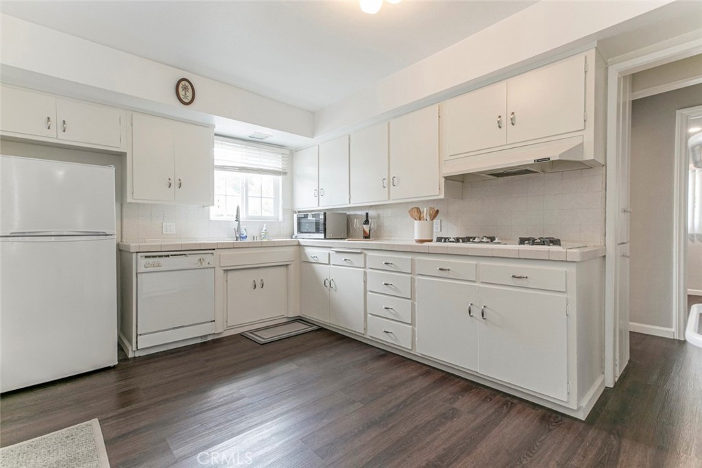 13166 Aztec Street Sylmar, CA 91342 - Photo 15 of 48 a kitchen with white cabinets white stainless steel appliances and sink