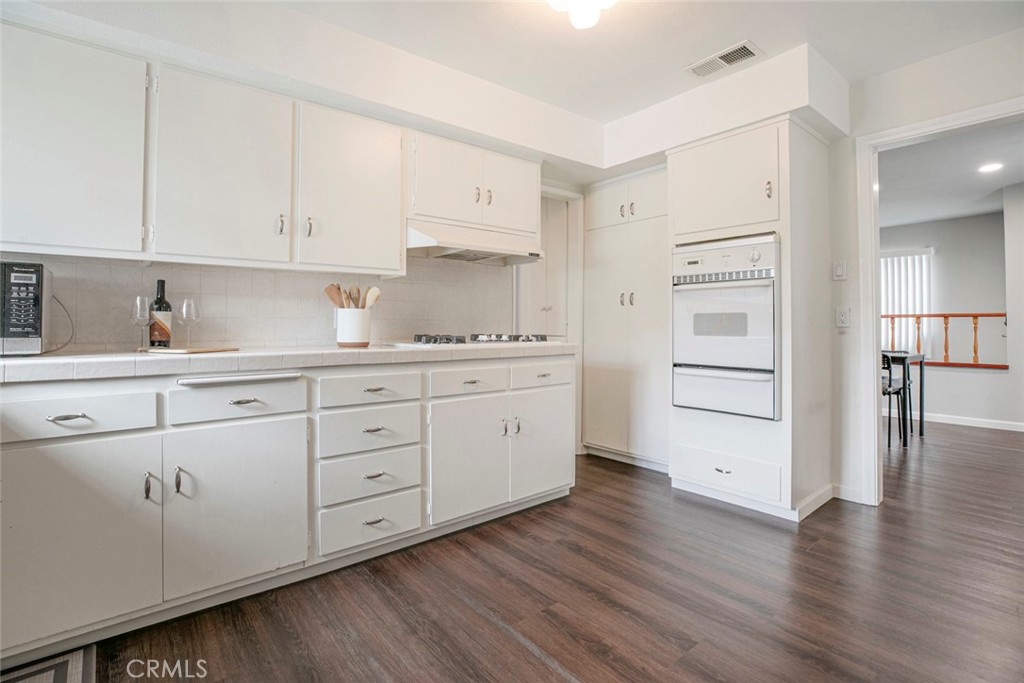 13166 Aztec Street Sylmar, CA 91342 - Photo 17 of 48 a kitchen with white cabinets sink and stainless steel appliances
