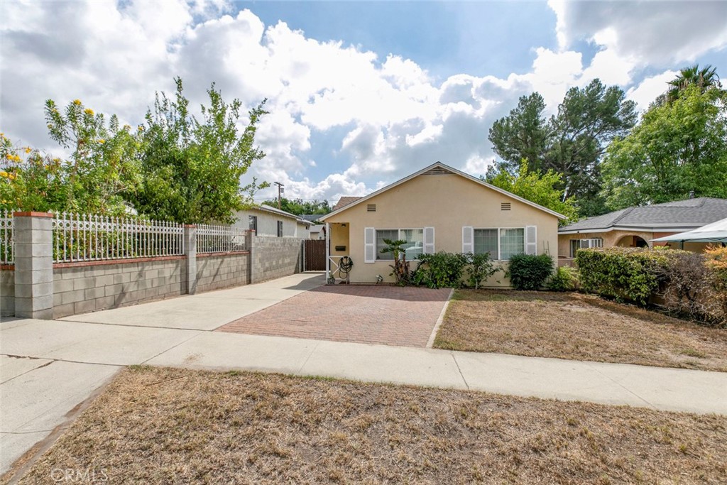 13166 Aztec Street Sylmar, CA 91342 - Photo 2 of 48 a view of a white house with a yard and large tree