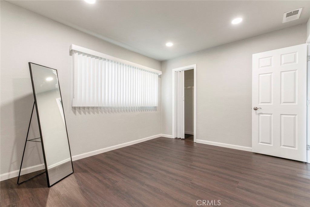 13166 Aztec Street Sylmar, CA 91342 - Photo 21 of 48 a view of an empty room with wooden floor and a window