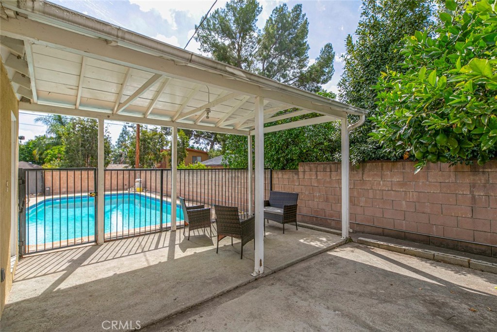 13166 Aztec Street Sylmar, CA 91342 - Photo 29 of 48 a backyard of a house with lawn chairs and iron fence